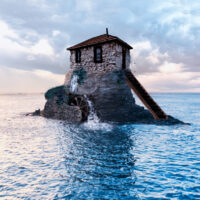 Haus im Meer mit Wasserrad